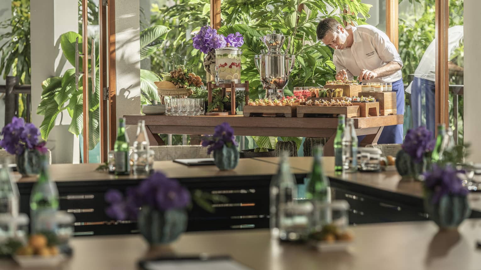 Chef puts finishing touches on canap�s in light-filled meeting room