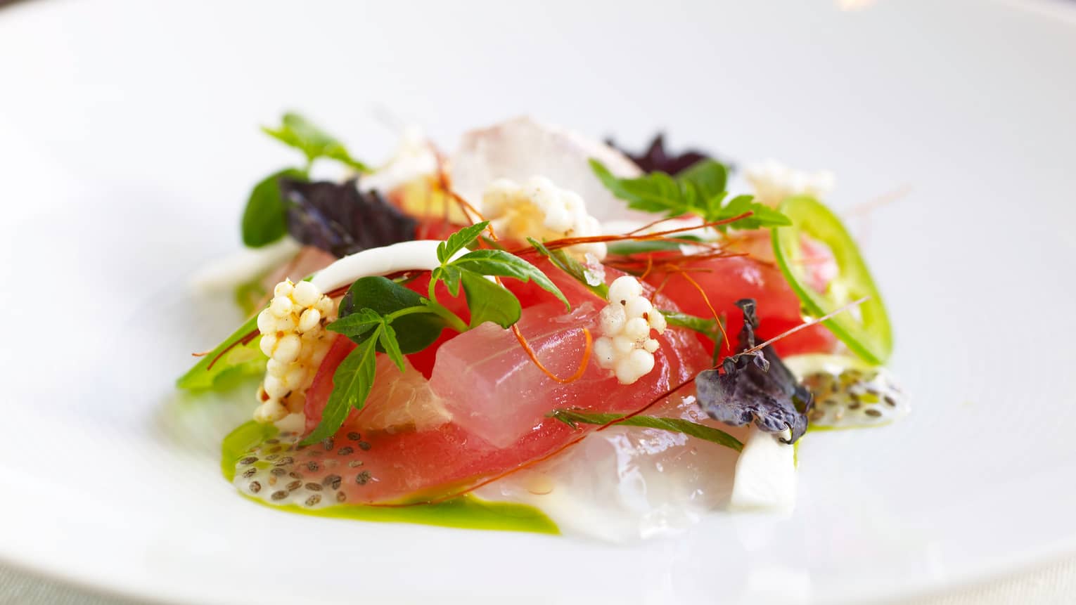Bourbon Restaurant Ahi Tuna Tartare raw fish garnished with greens, Asian pear, ancho chili