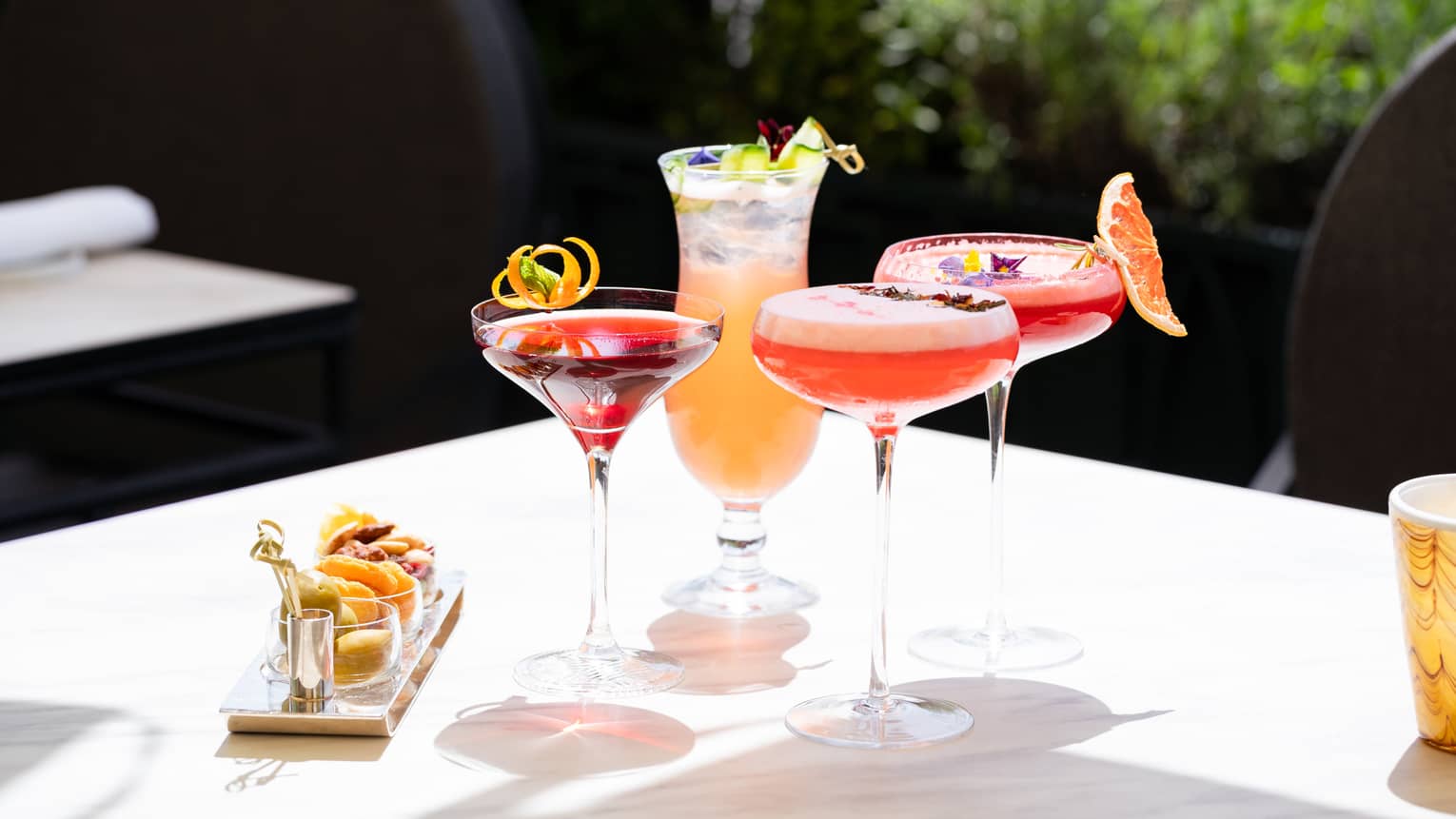 Assorted summer cocktails and bar snacks
