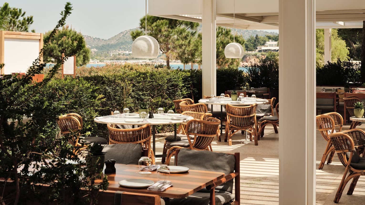 A spacious outdoor dining patio with a mountain and water view
