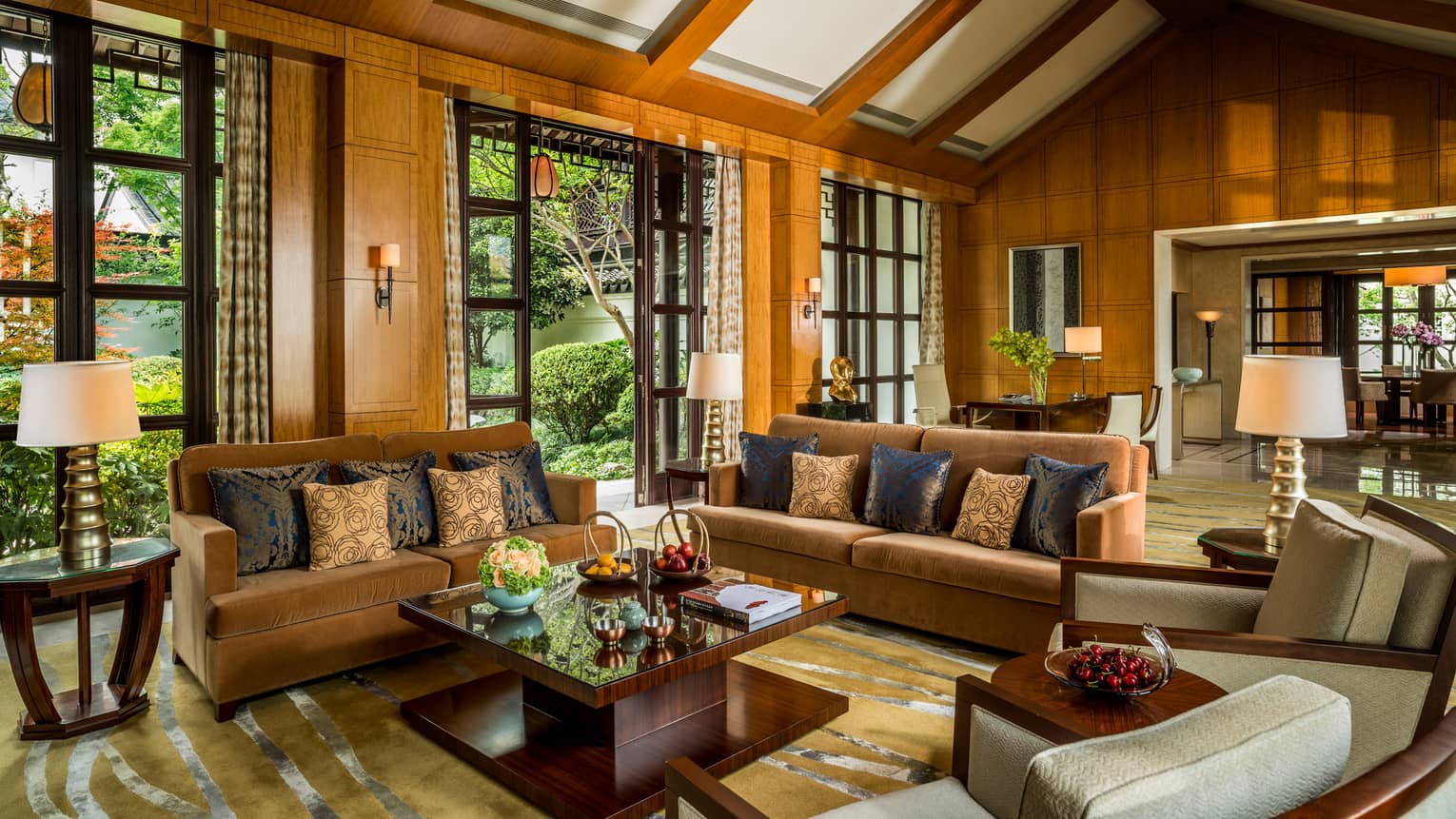 Presidential Villa with two orange velvet sofas, chairs around modern wood table