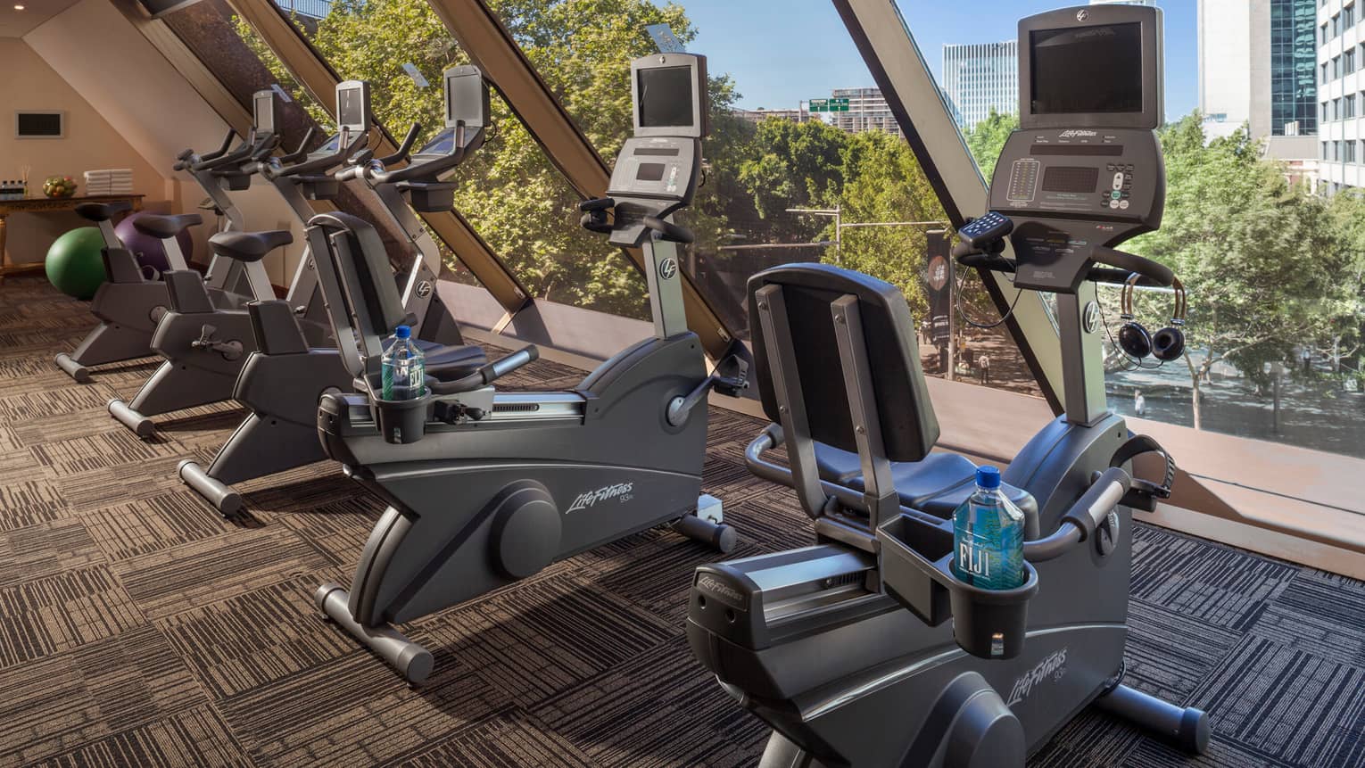 Cardio bikes, machines lined up by window in Fitness Centre