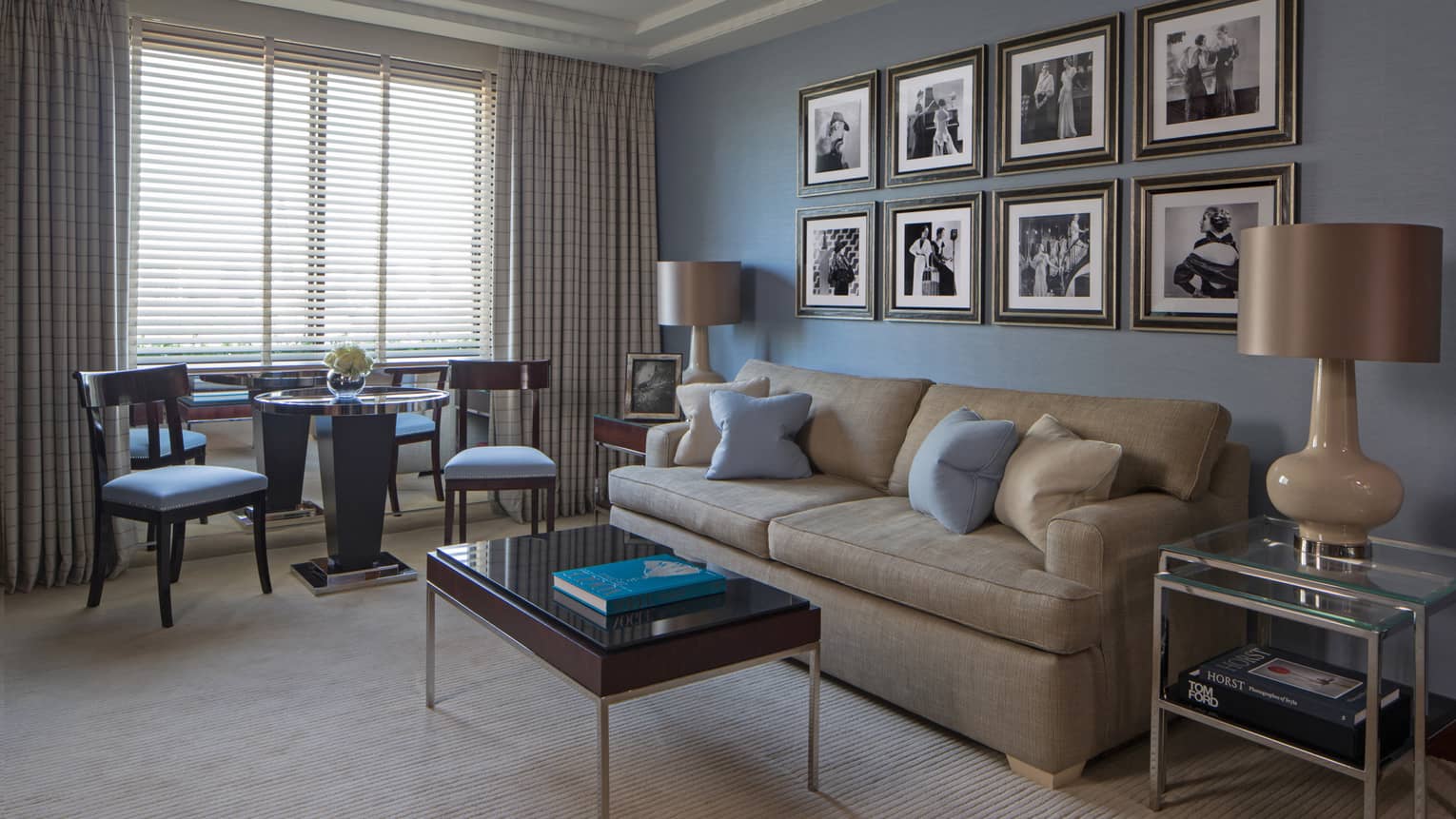 Westminster Suite sofa, table under rows of black-and-white prints, table, chairs by window