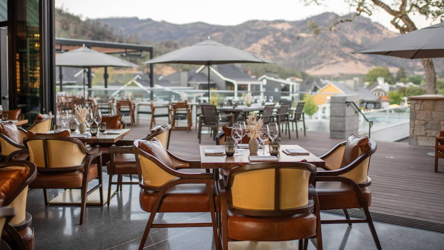 Restaurant dining room opens to wooden patio with umbrellas