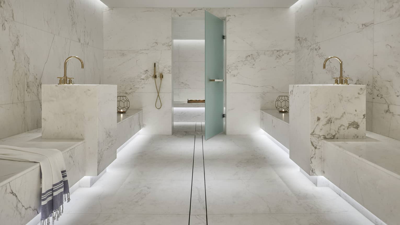 Tropical Hammam escape in white marble spa room, towel draped over side 