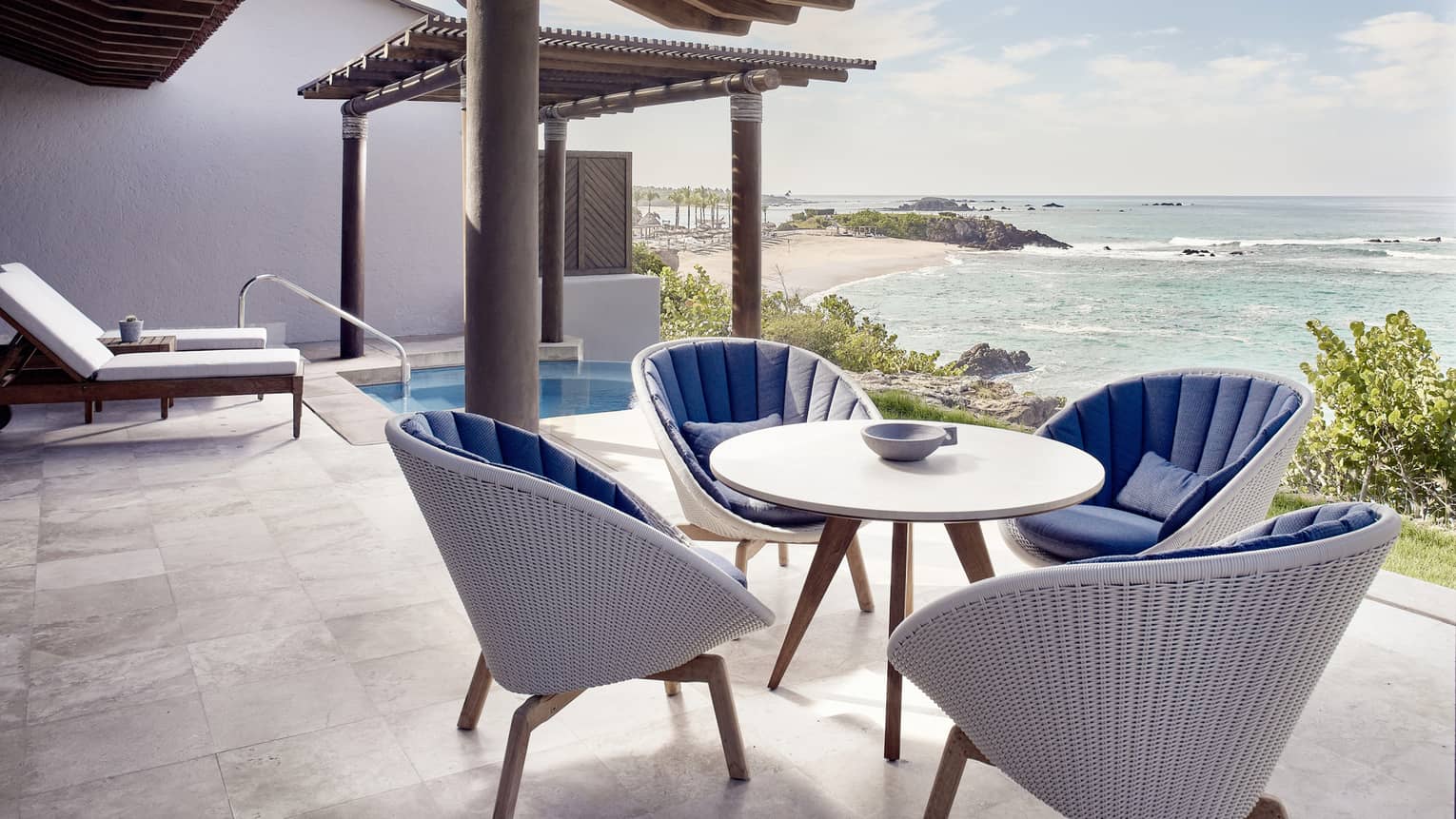 Outdoor terrace, dining table with four wicker chairs, plunge pool, ocean view