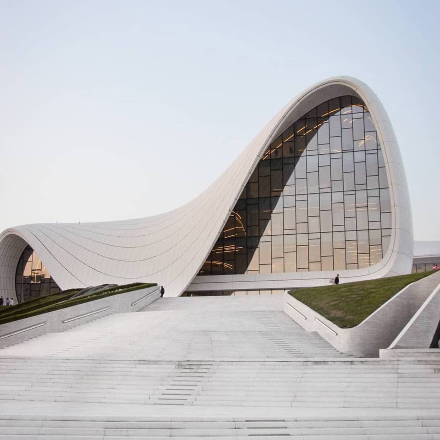 Concrete path leading up to Heydar Aliyev Center concrete building with arced shape