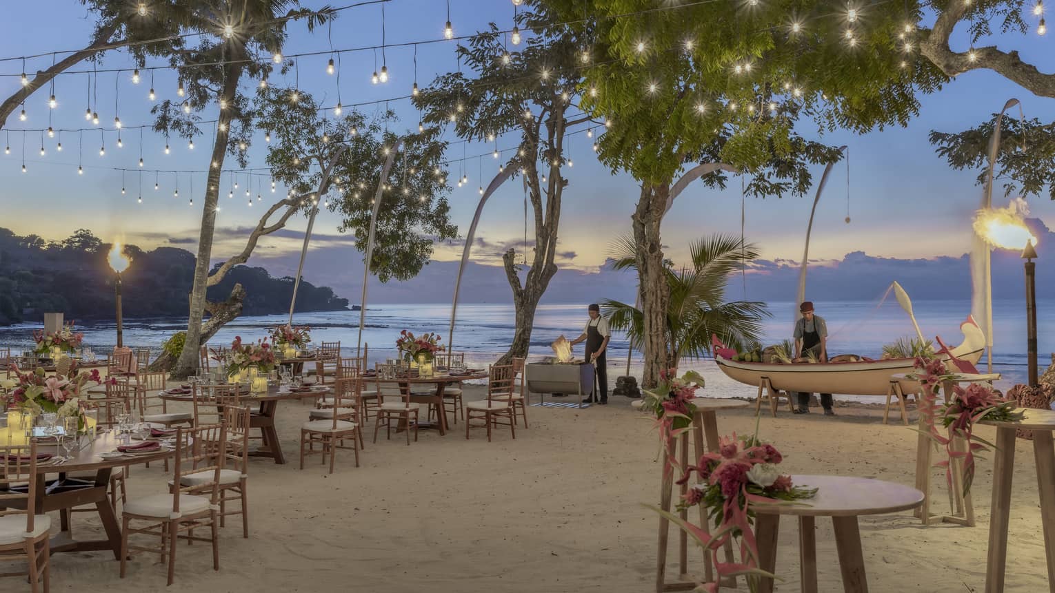 Beachside dinner setup with string lights