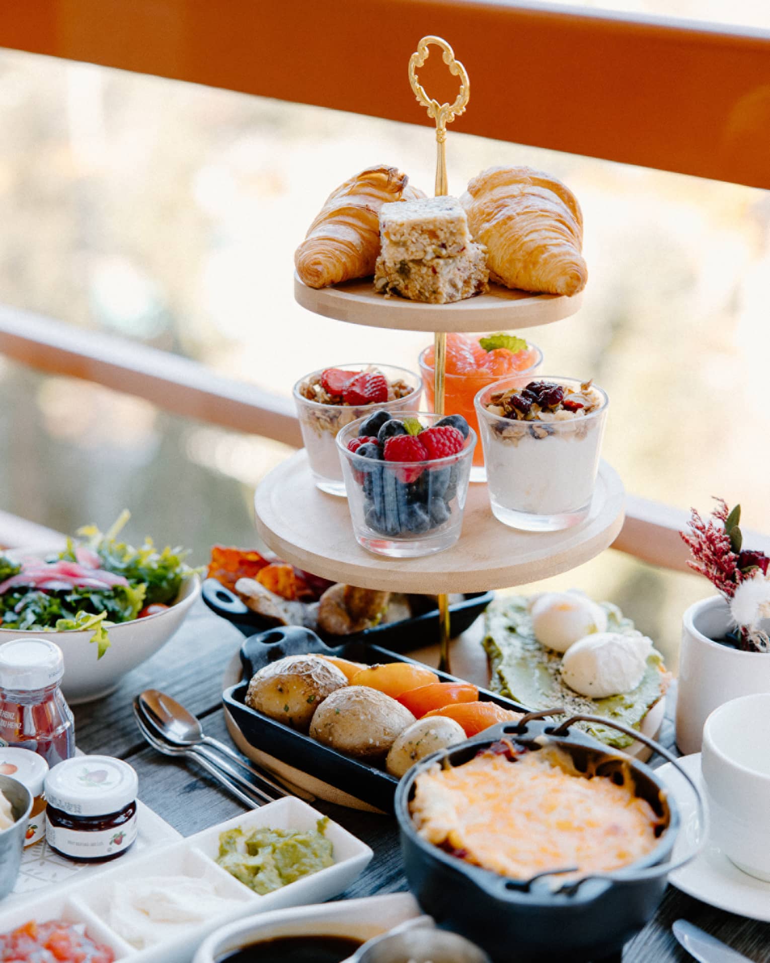 Three-tier tower with breakfast spread on outdoor table