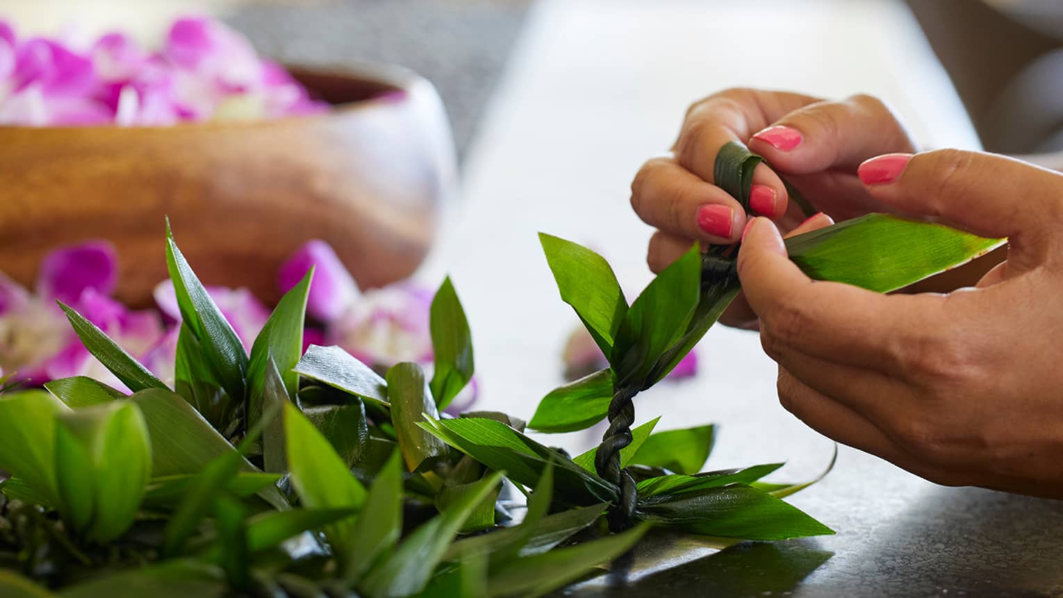 Guests weave leis out of fresh materials