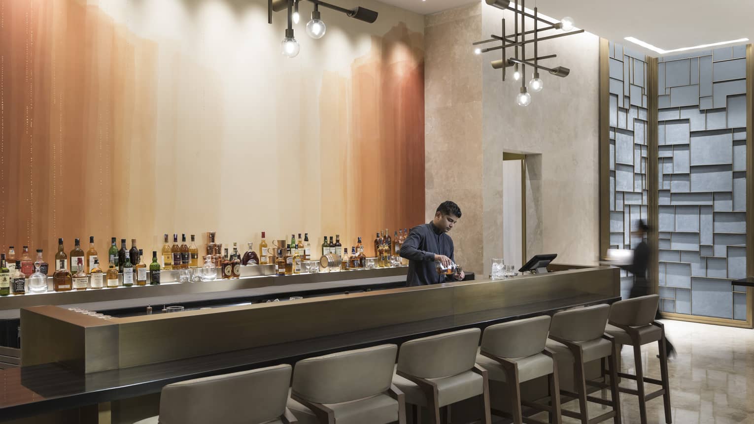 A bartender mixes a drink at the Collection bar