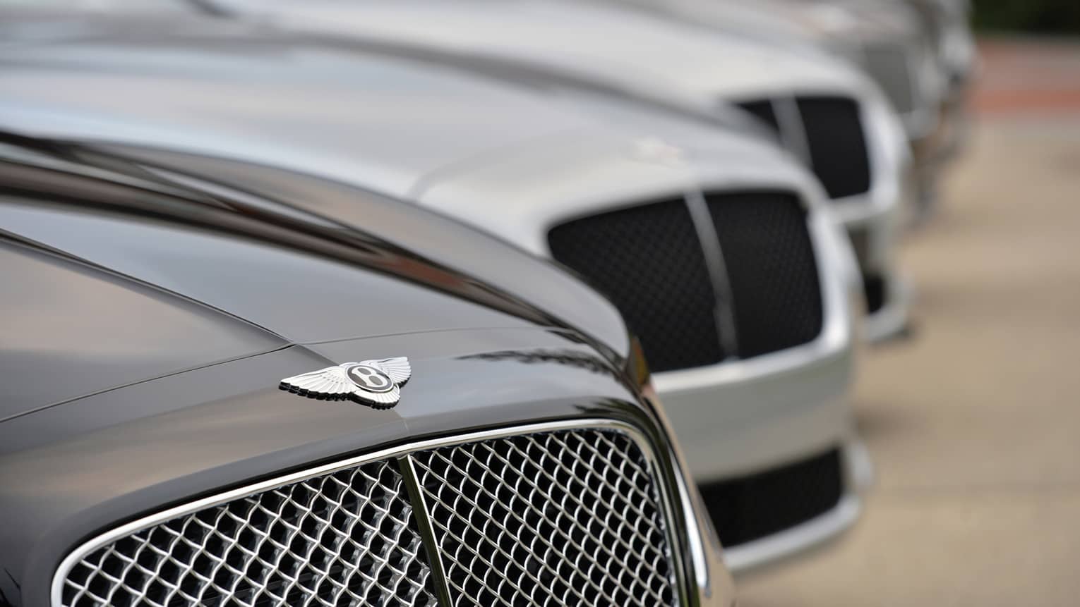 Close up of Bentley car, as part of line up of luxury cars