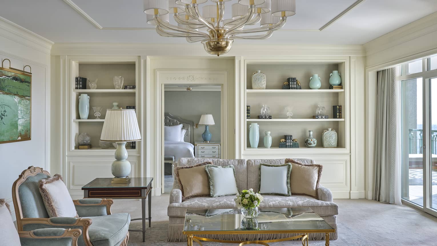 Elegant hotel suite living room with built-in shelves featuring different vases
