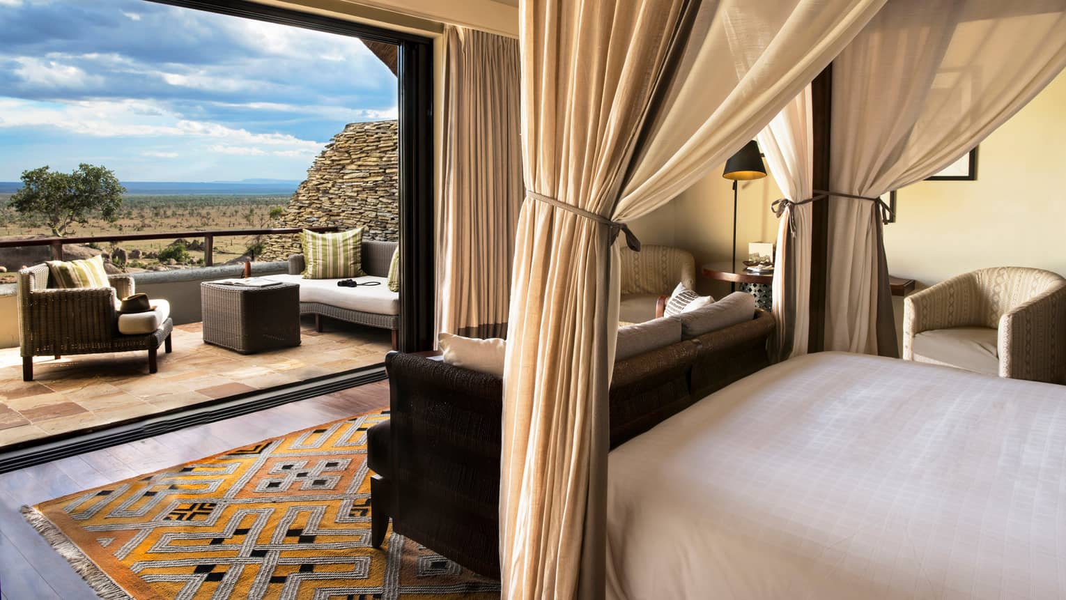 Horizon room from the perspective of a poster bed. Includes a tied canopy, colourful carpet, open patio wall