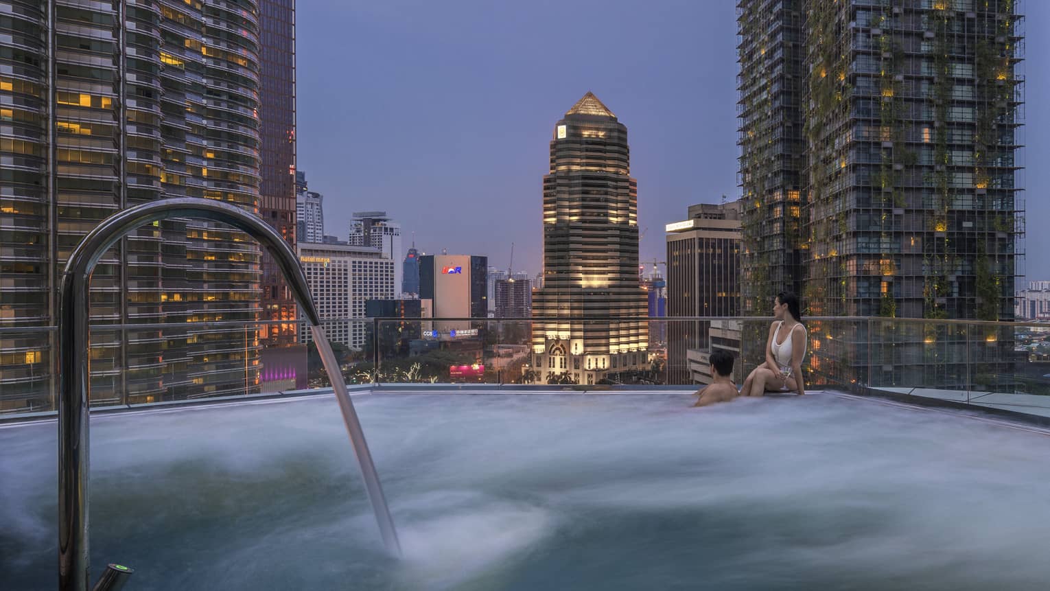 Pool with a view of the city skyline at Four Seasons Hotel Kuala Lumpur