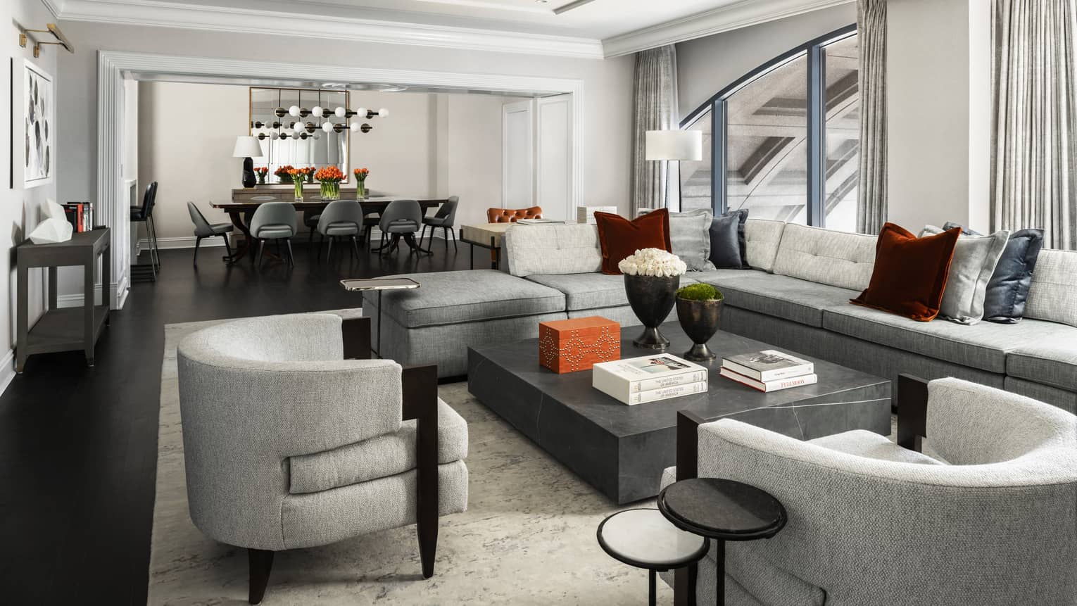 Presidential Suite large seating area with modern grey furniture, dining table