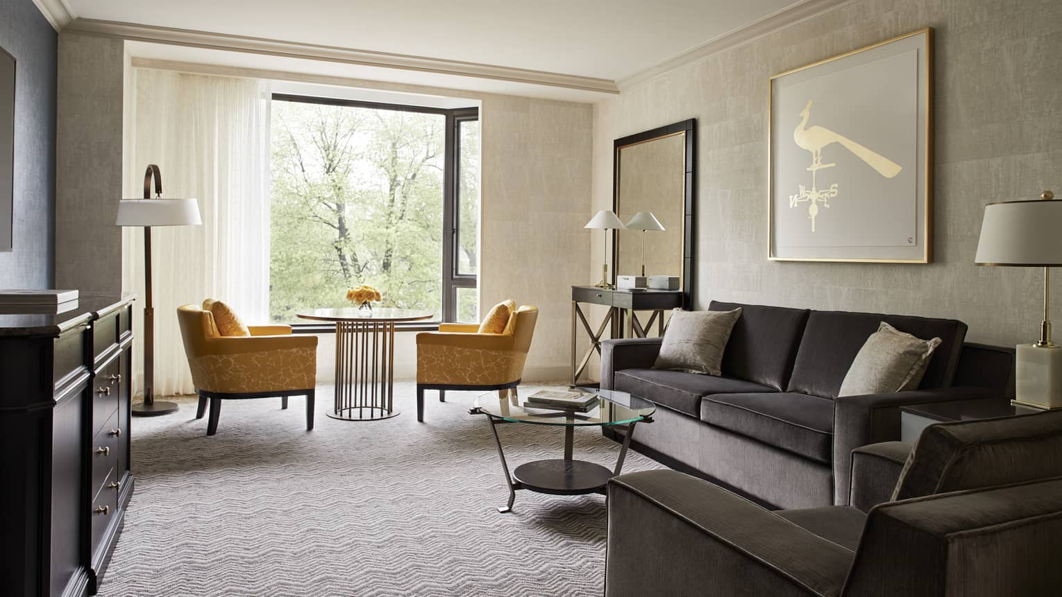 Garden View Executive Suite grey velvet sofa and armchair, golden yellow plush armchairs beside bright window
