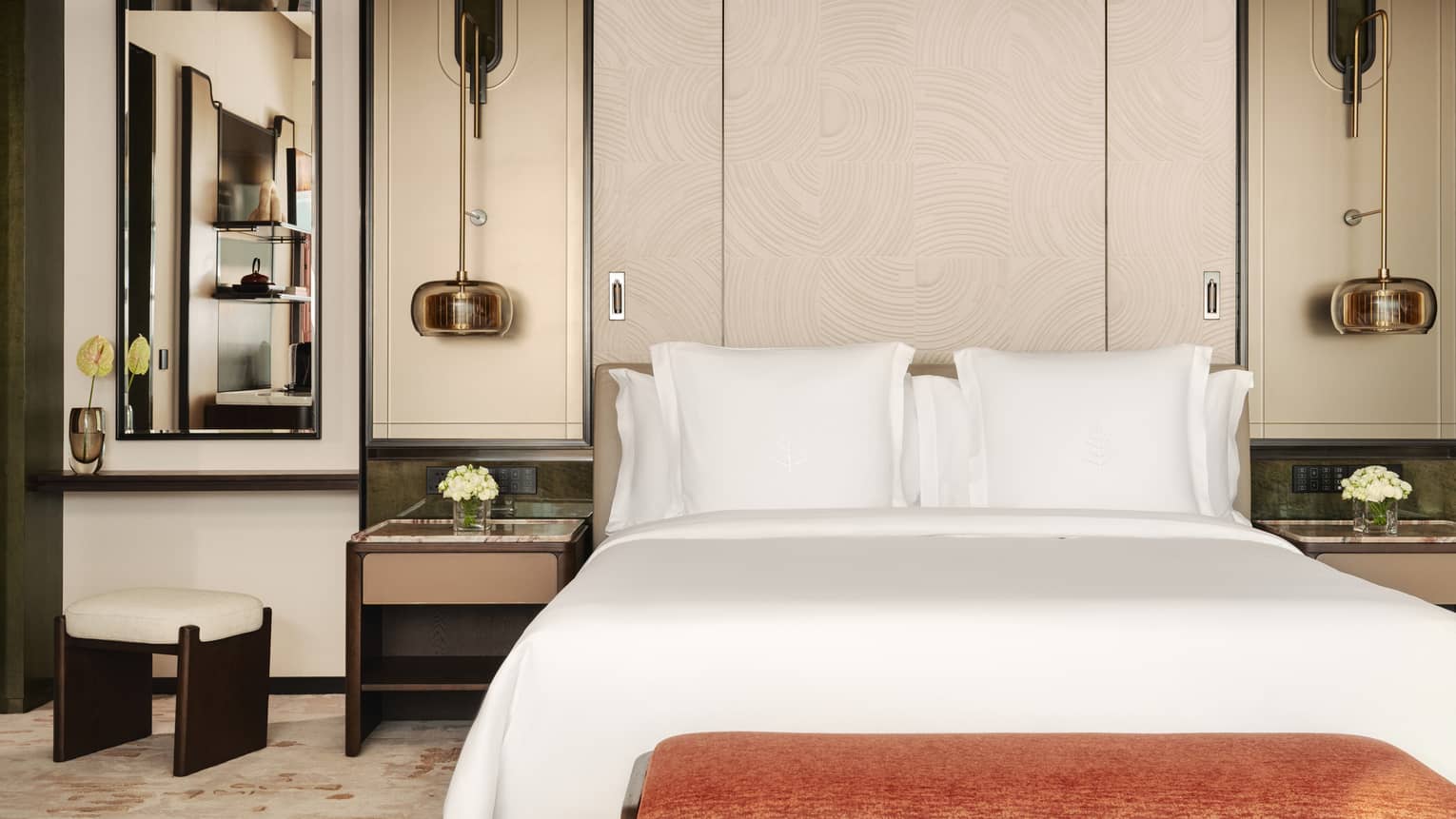 Hotel room king bed, with two side tables and hanging light fixtures