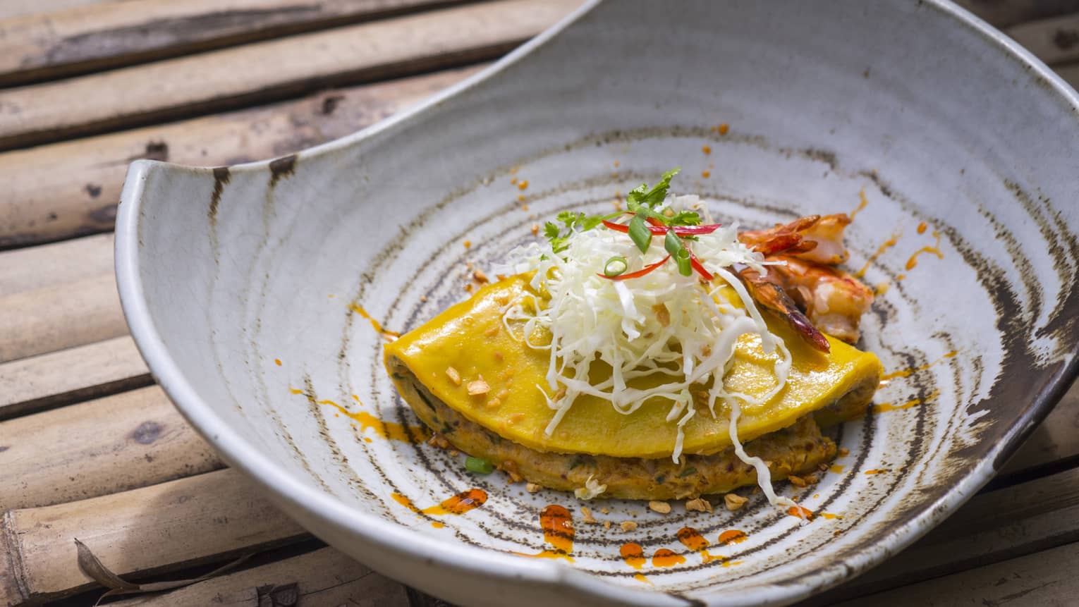 Asian dish with garnish served in pottery bowl 