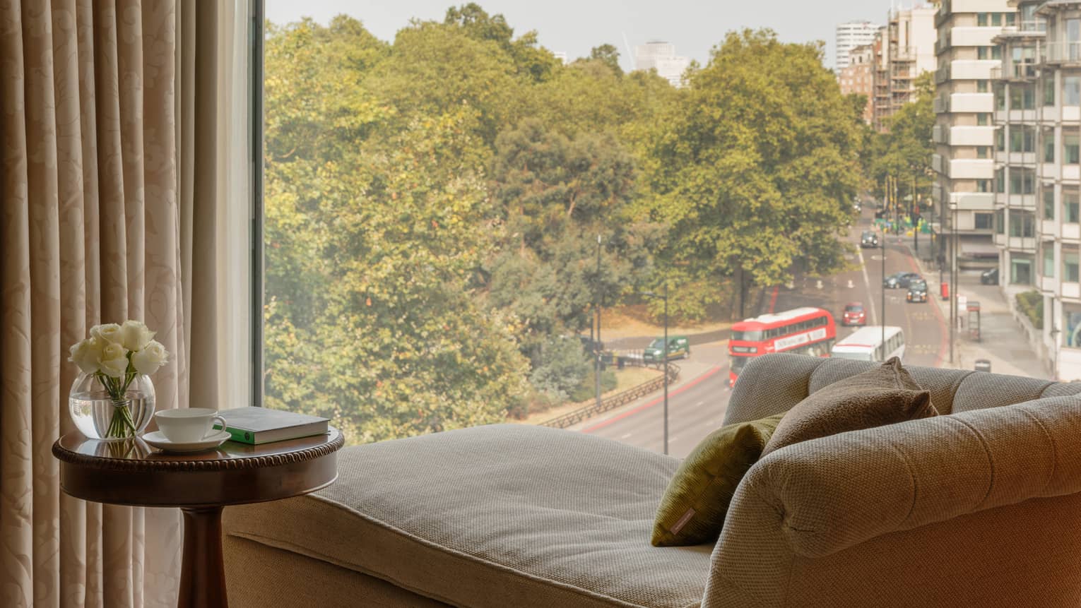 Chaise longue facing a window, overlooking London city street and park