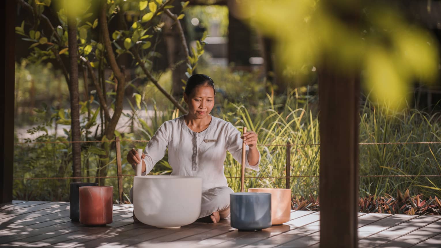 Maldivian woman plays Lastri singing bowls