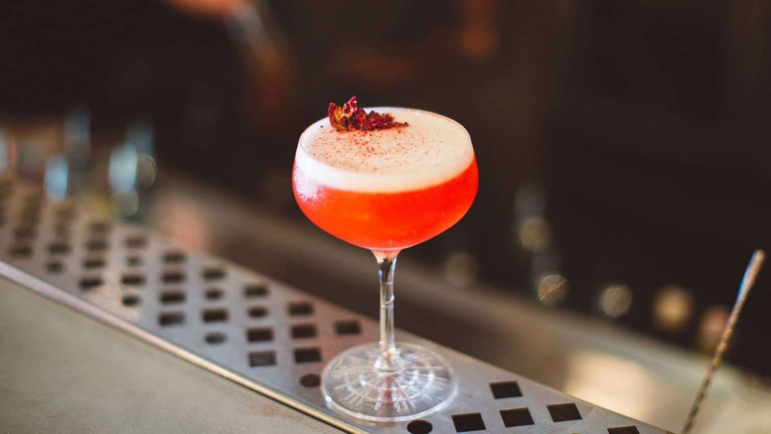 A blood orange martini with a red topping. 