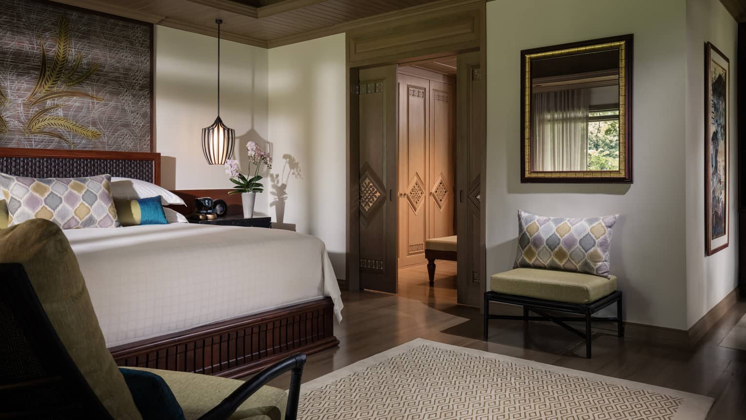 Garden Pavilion room corner of bed, hanging lamp above nightstand, chair beside sliding wood doors