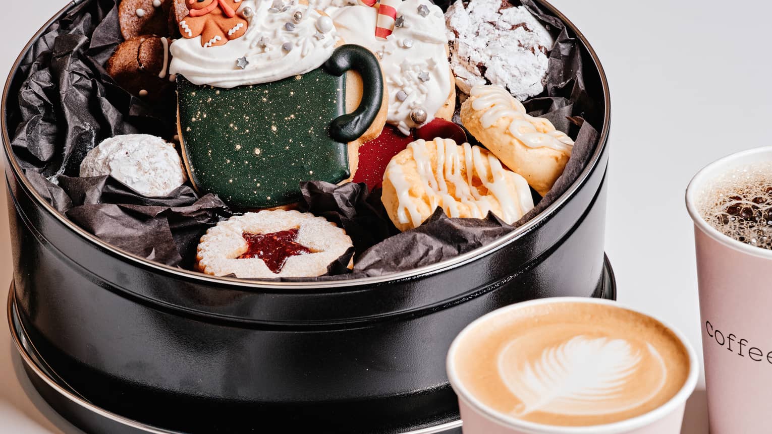 An assortment of holiday cookies and coffee.