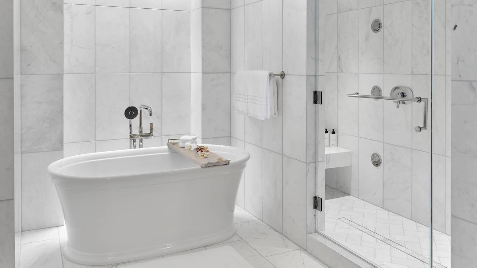 Marble bathroom with large walk-in shower and sleek standalone tub
