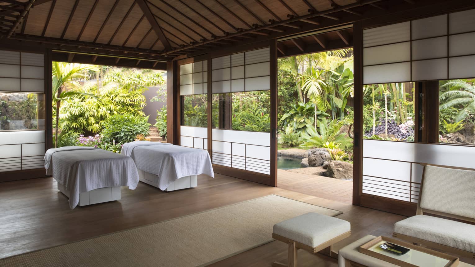 An airy indoor spa surrounded by lush flora