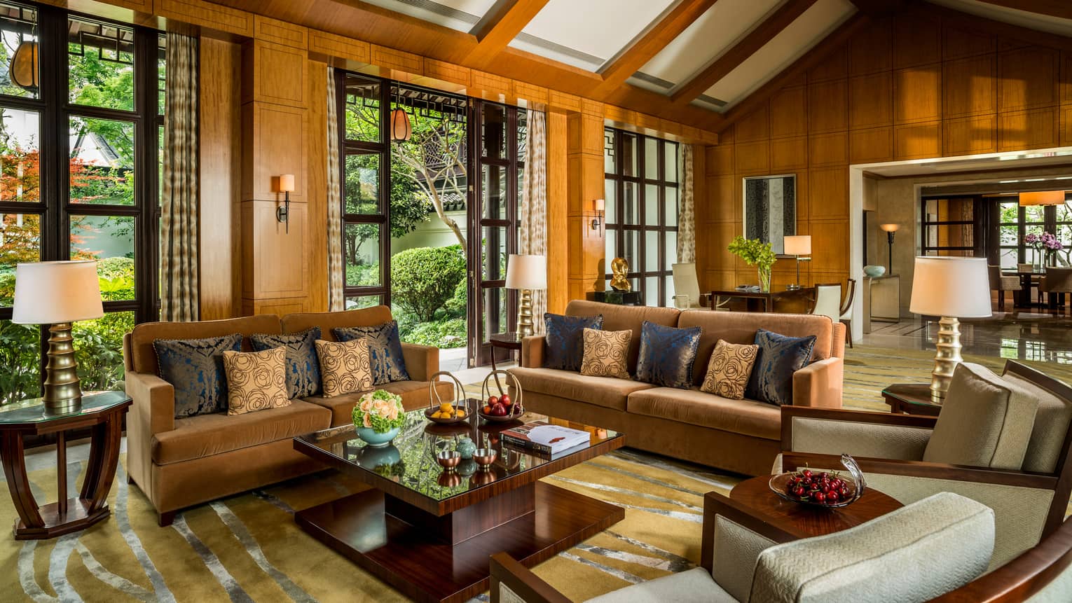 Presidential Villa with two orange velvet sofas, chairs around modern wood table