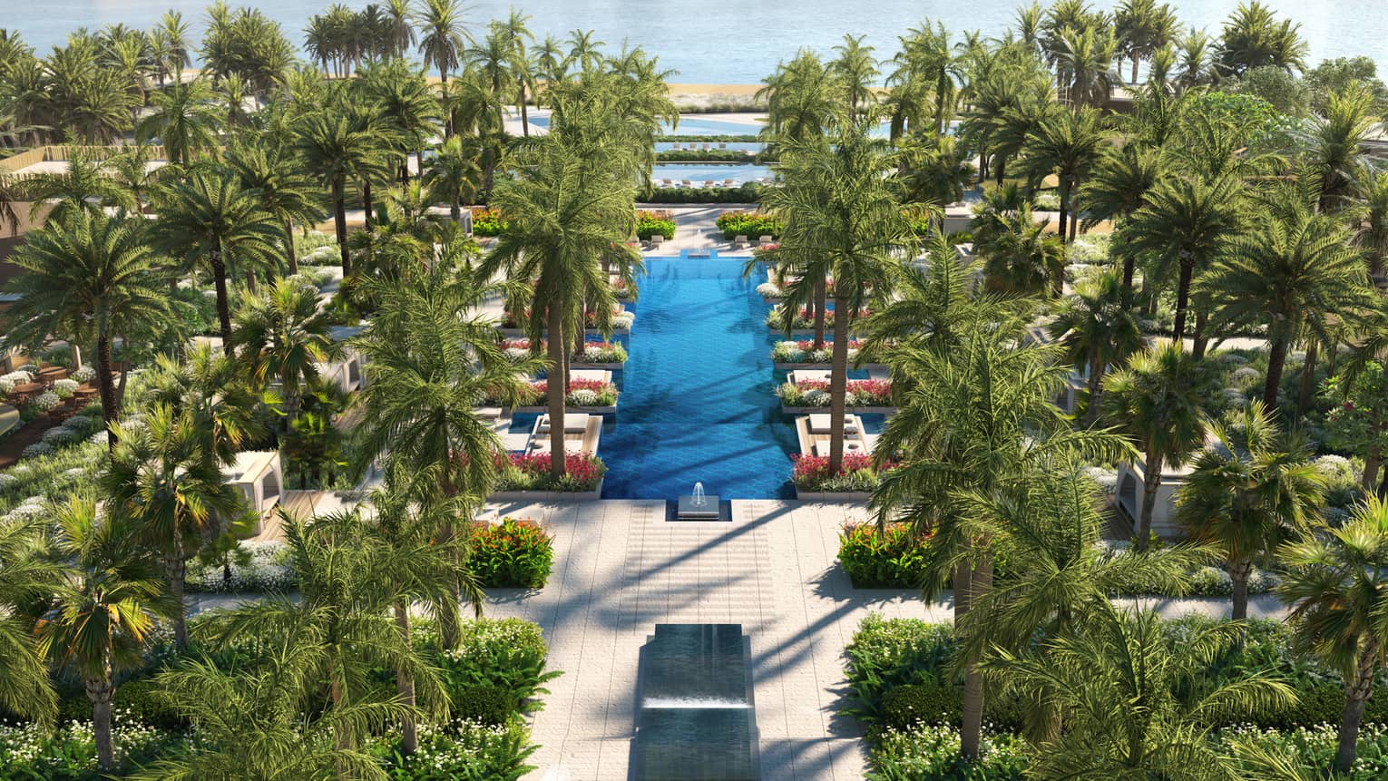 A luxury pool with palms leading to the sea.