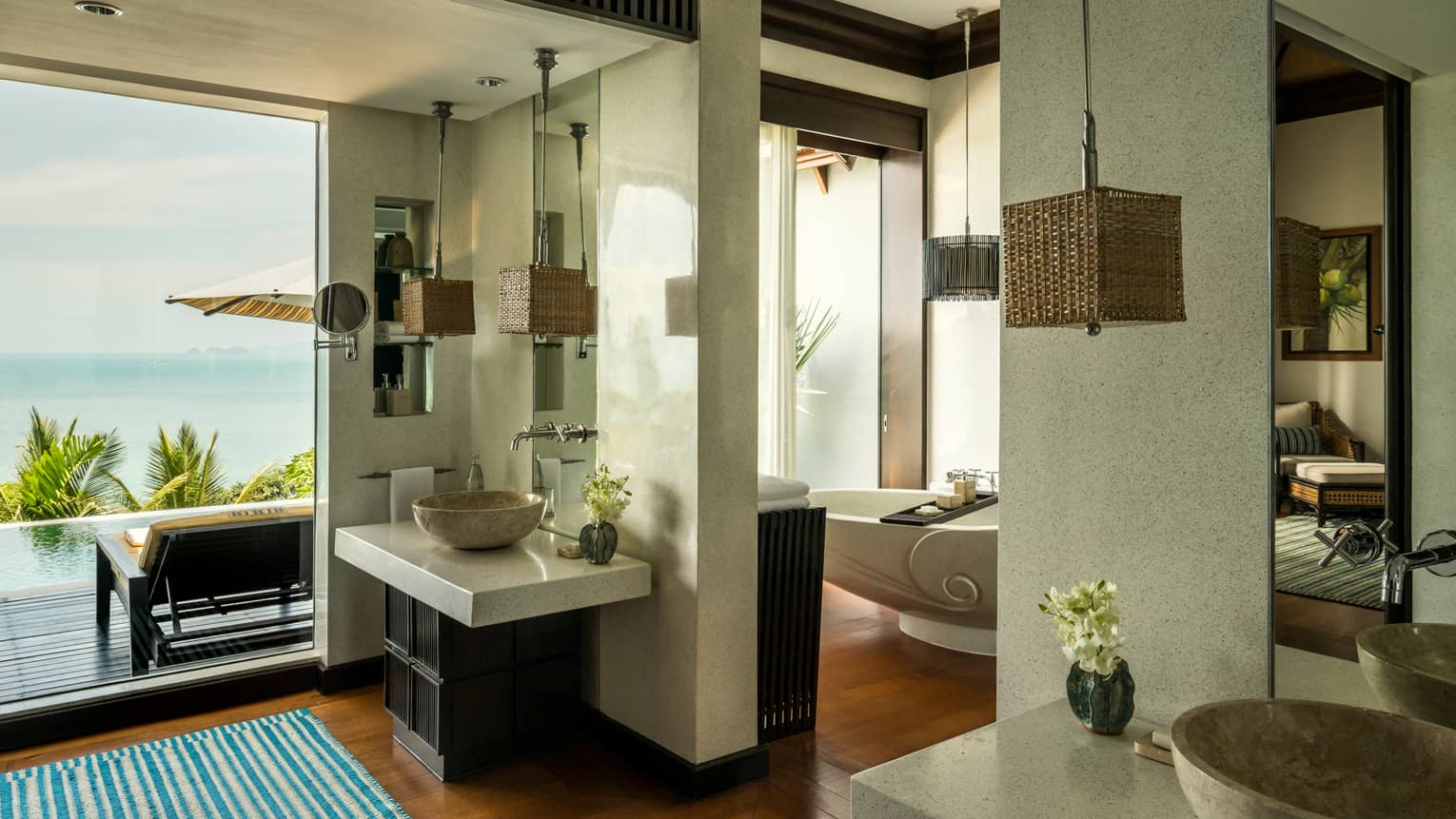 Villa bathroom with double marble sinks, freestanding tub, floor-to-ceiling window