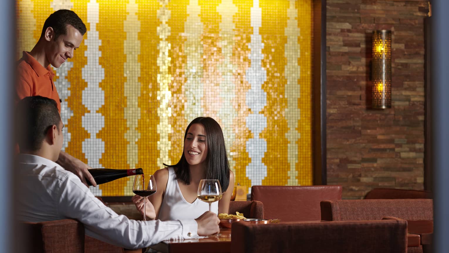 Couple enjoys a casual meal with wine at Aura