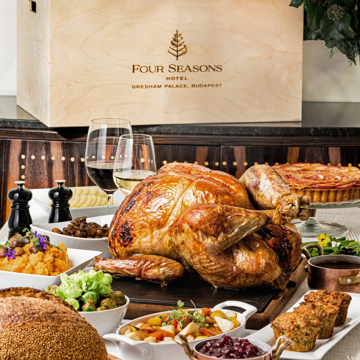 Thanksgiving food on trays such as turkey, breading, wine, stuffing, and pie.