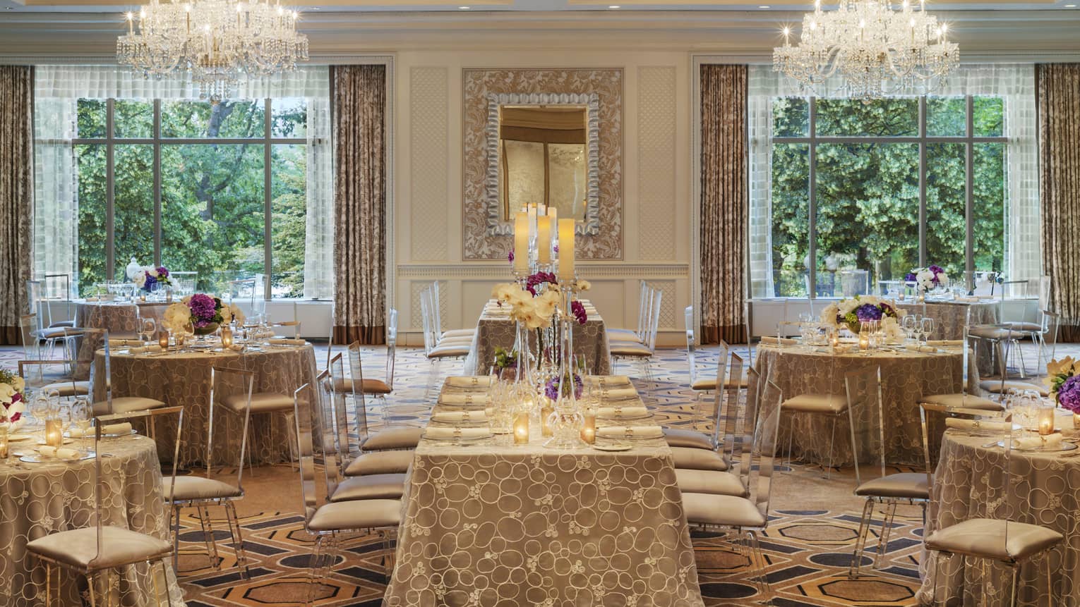 Ballroom Social setup with tables, chairs under two large windows, crystal chandeliers 