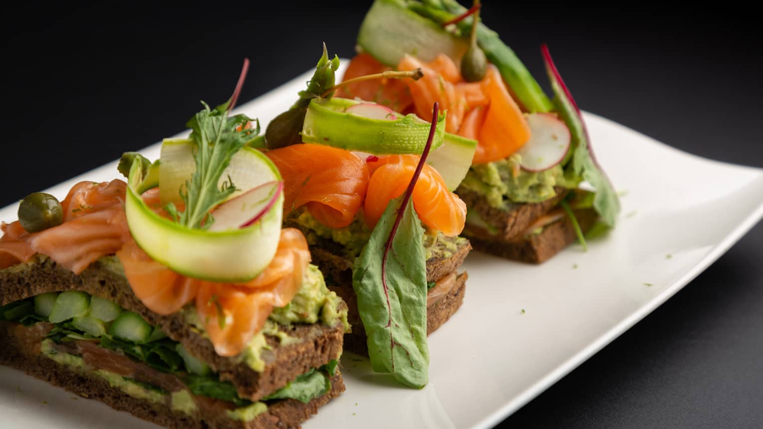 Scottish smoked salmon club sandwich with avocado, sucrine lettuce and radish