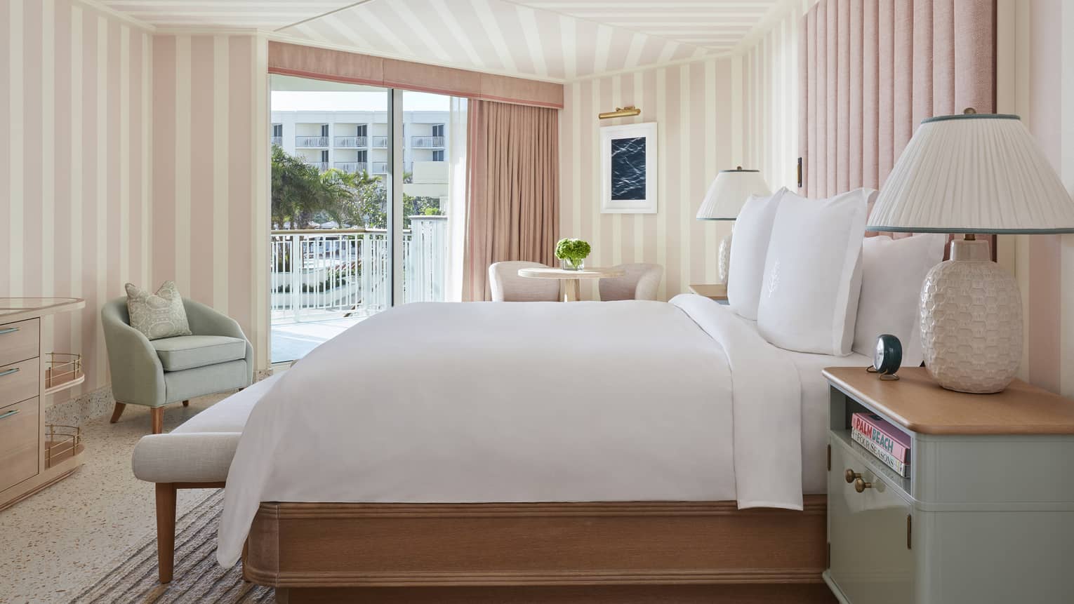 Ocean View Cabana Terrace Room hotel bed, lamp against pink and white walls