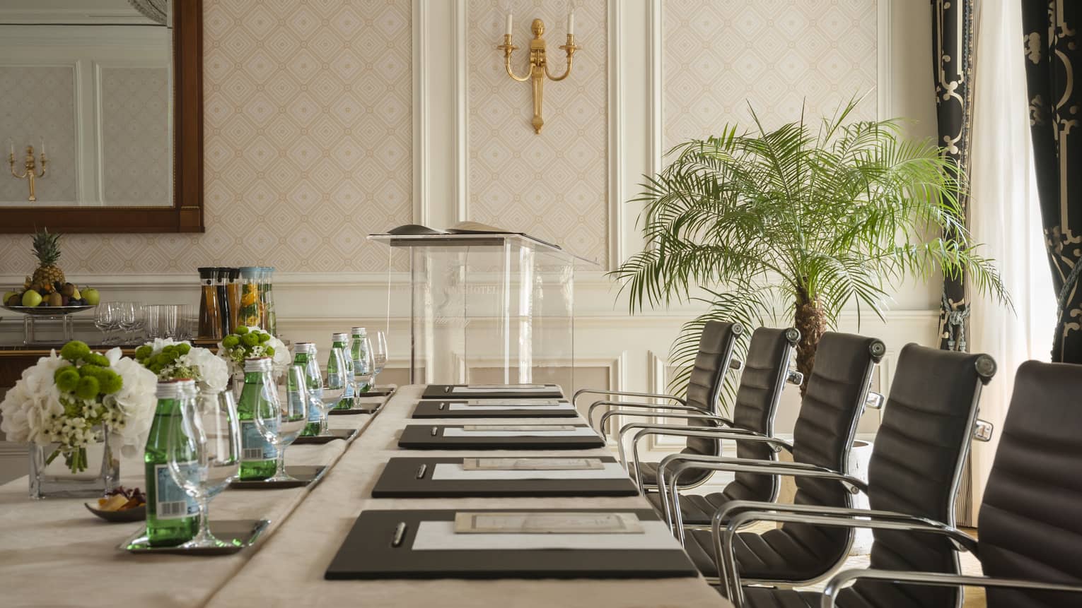 Phipps Room elegant boardroom meeting table lined with black executive chairs