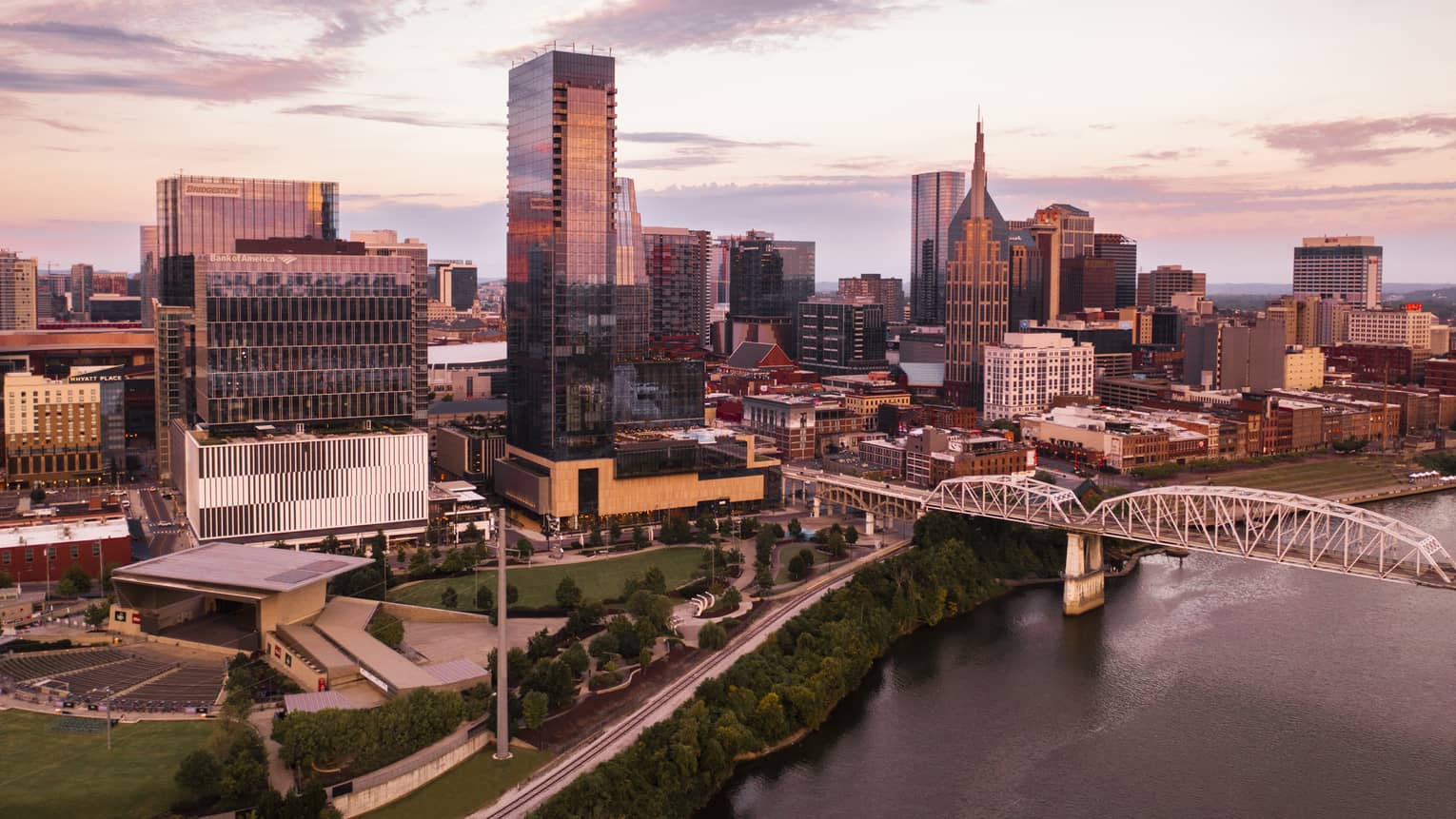 A city skyline near a bridge and water.