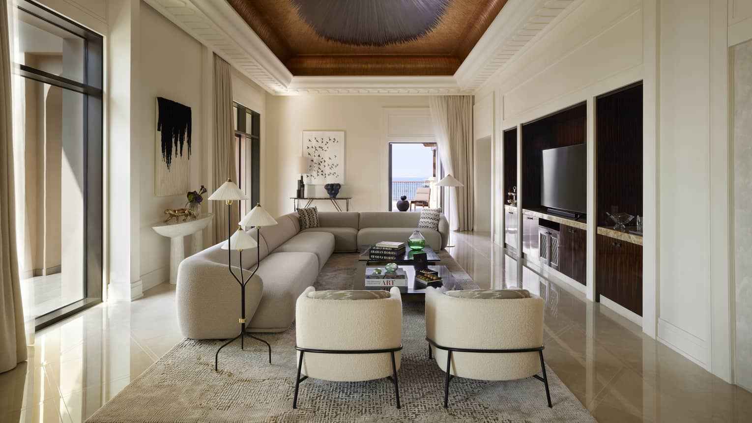 Contemporary Presidential Suite living room with taupe sofa and two arm chairs, under a painted ceiling