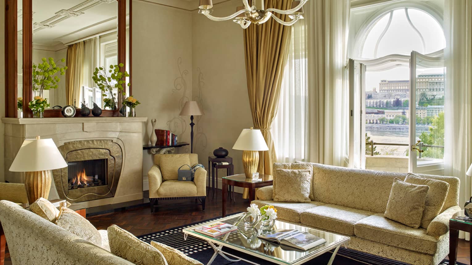 Sir Gresham Presidential Suite velvet sofa with ivory roses by fireplace with large mirror above mantel