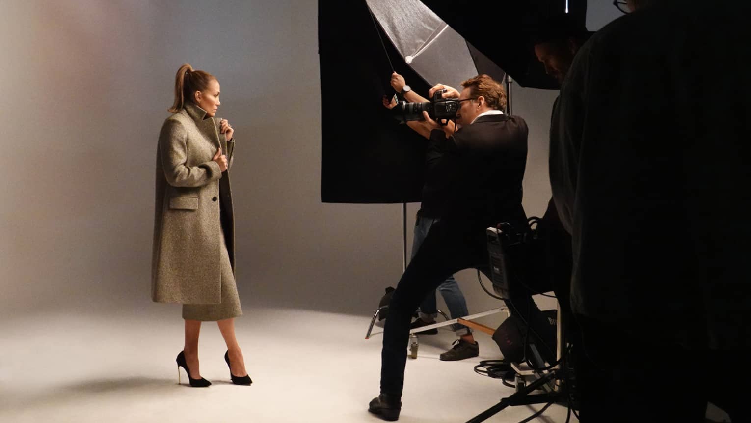 A woman in a coat in a photoshoot.