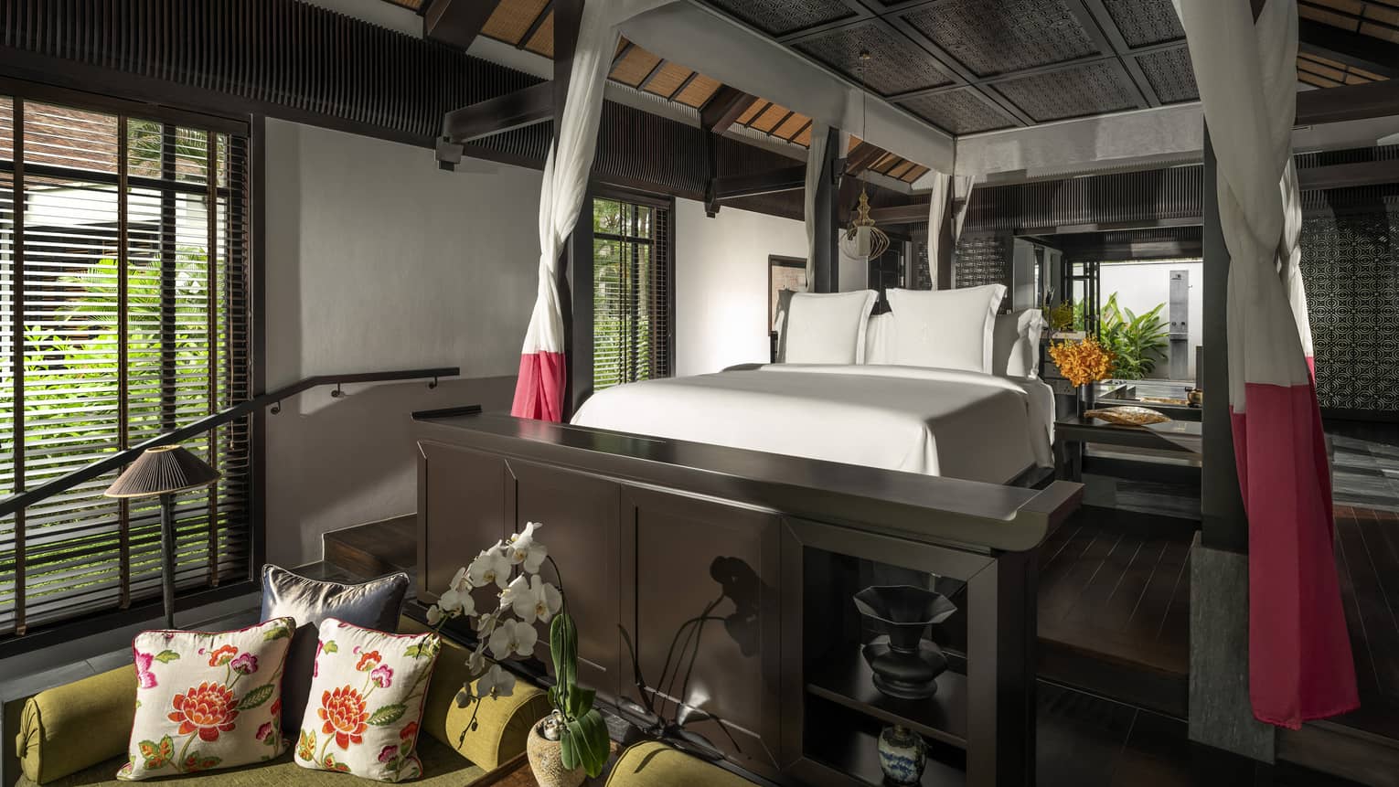 Luxury resort room with netting around the king bed and sitting area