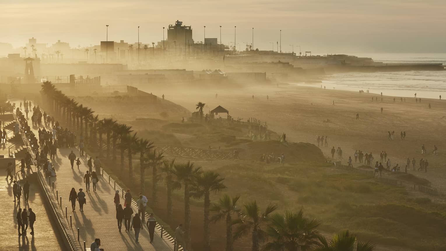 Silhouette of misty Casablanca beach, boardwalk at sunset