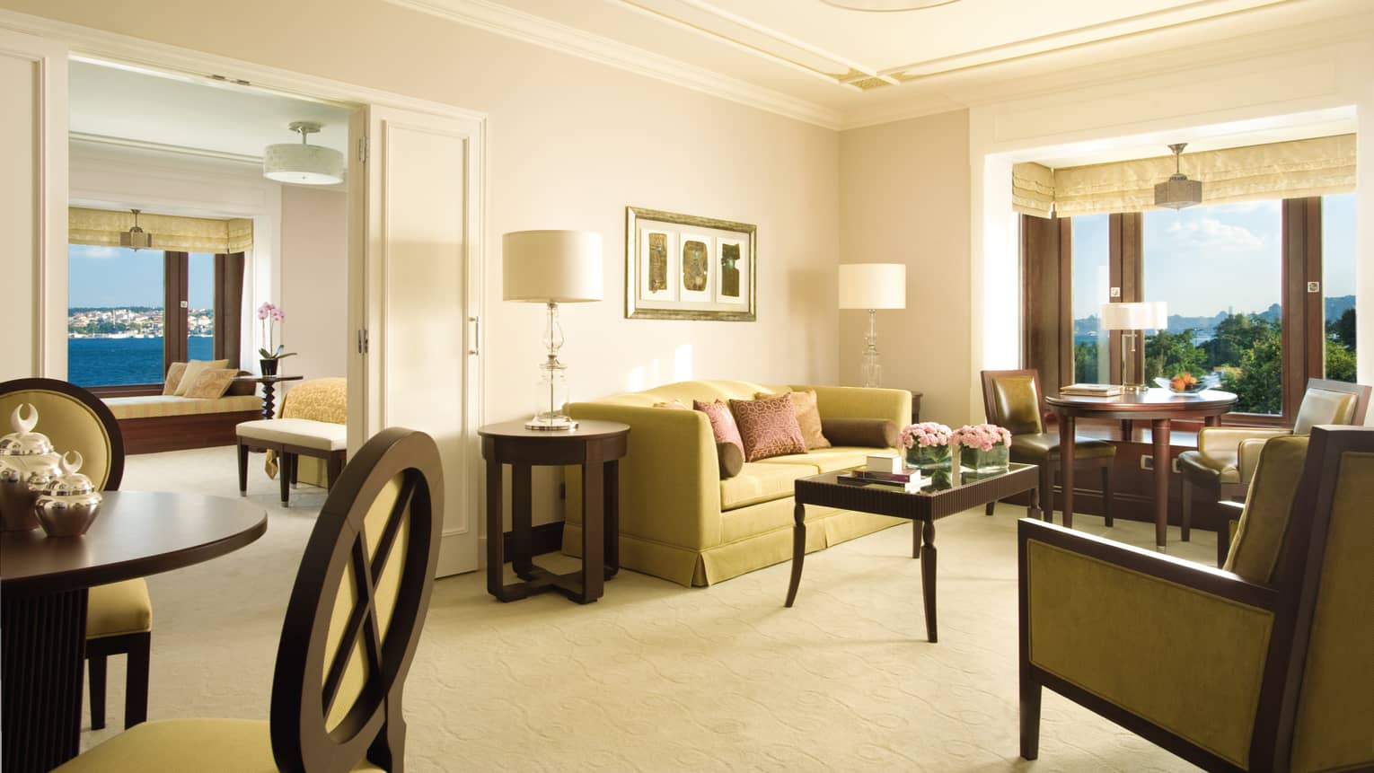 Bosphorus Suite seating area, small round dining table in front of bay windows, bedroom doors