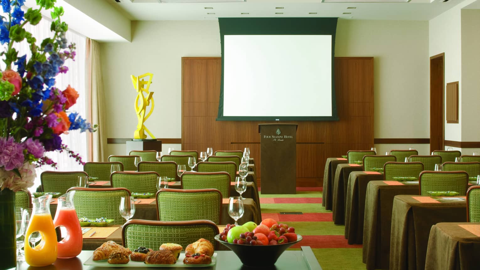 Gateway Meeting Room, rows of small meeting tables face podium, breakfast station