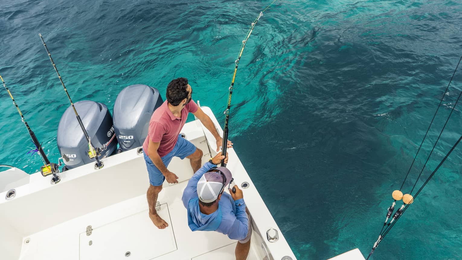 Two men deep sea fishing.