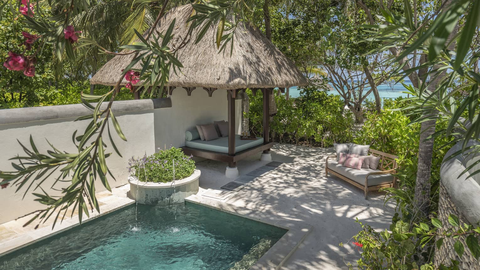 Private pool with thatched-roof cabana