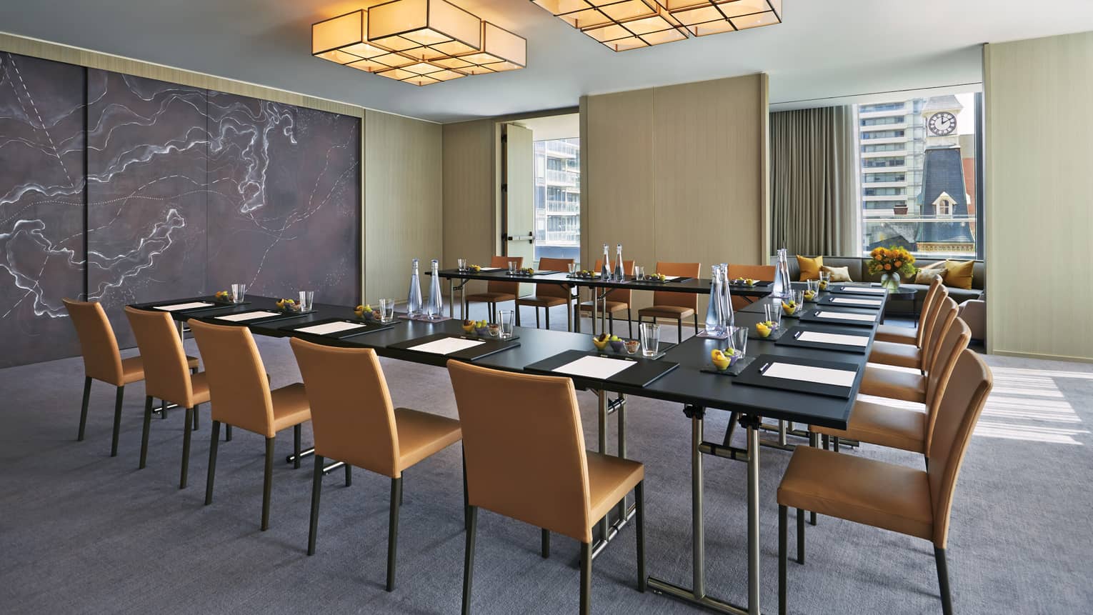Modular meeting table under square lights, modern marble accent wall